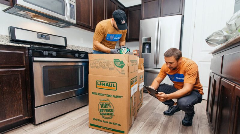 Smoove movers packing a kitchen into boxes
