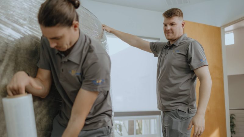 Smoove movers protecting a large flat item before loading