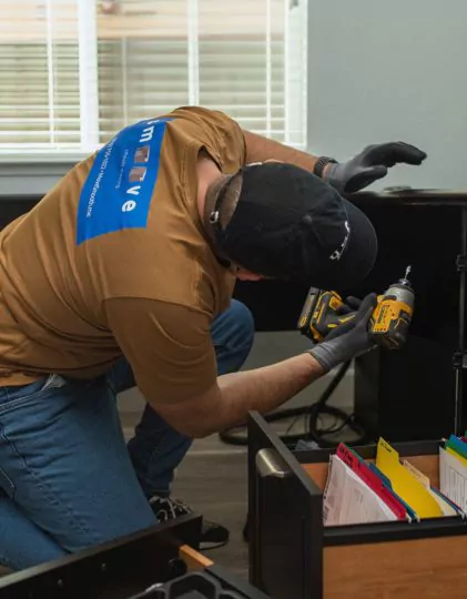 Smoove mover disassembling furniture with a power drill